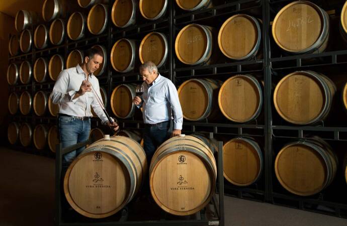 Image of two gentlemen doing a tasting in the winery.