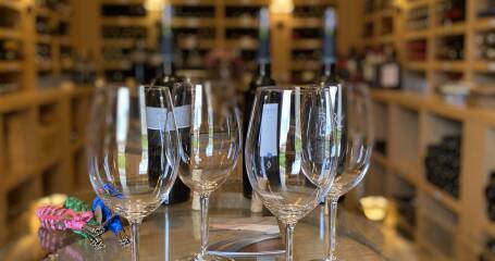 Image of wine glasses on a barrel.